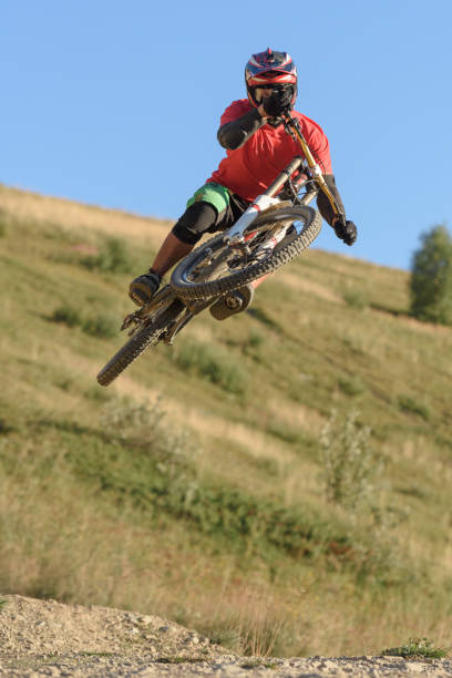 istock Man jumping in midair with mountain bike 905938538