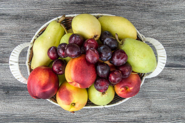 istock summer fruit, fruit basket, apple, pear, peach, nectarine and plum 905938574