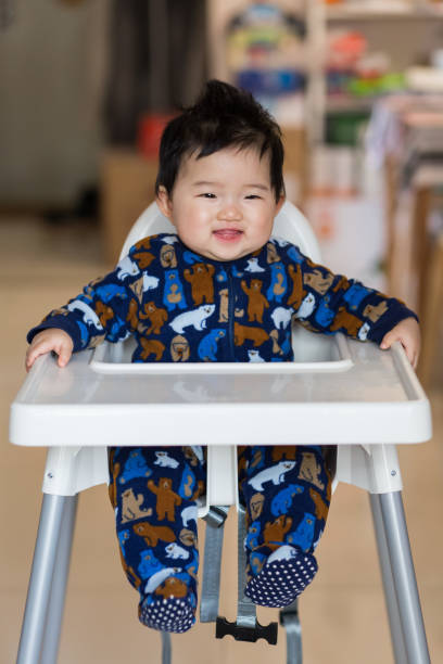 istock Baby sitting in a high chair 905938766