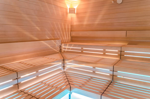 Modern wooden Finnish sauna interior with fresh birch whisk.
