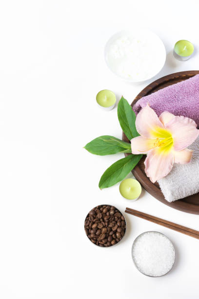istock Spa setting of towel, flower, coffee on white. Copy space. Relax. 905945062