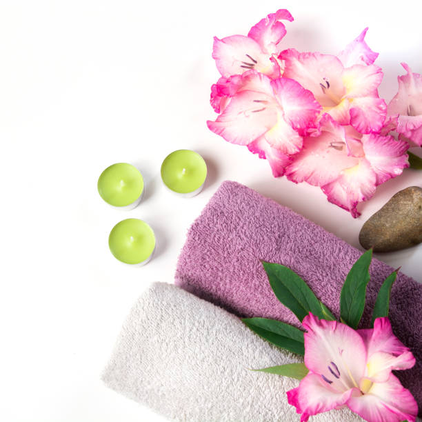 istock Spa setting of towel, flower, coffee on white. Copy space. Relax. 905945066