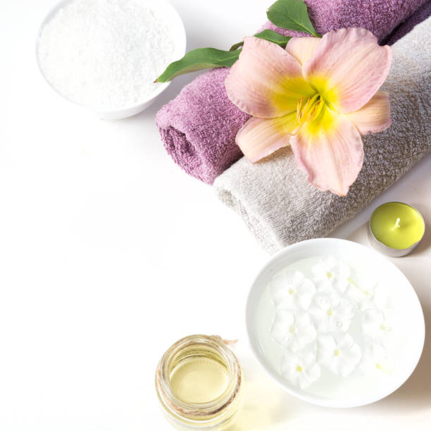 istock Spa setting of towel, flower, coffee on white. Copy space. Relax. 905945074