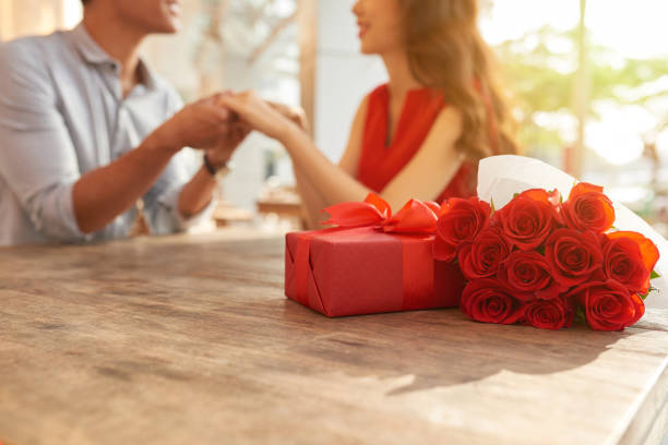 A mixed race couple enjoying chocolates together