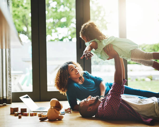 bonding at home - fun family couple happiness imagens e fotografias de stock