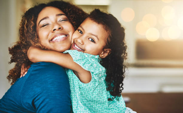 Enjoying love beyond measure Shot of a young mother and her daughter spending quality time together at home lens flare offspring daughter human age stock pictures, royalty-free photos & images