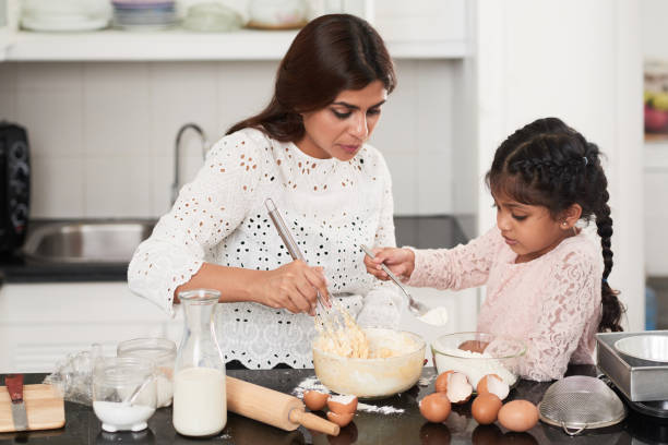 istock Indian Family Wrapped up in Cooking 905949358