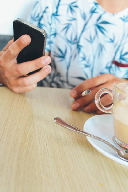 istock Smoking cigarette and spending time on the phone 905949496