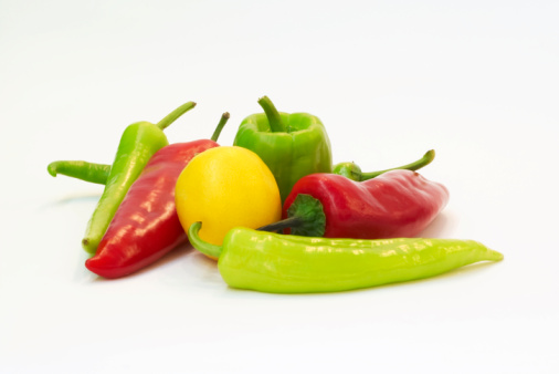 Basket of freshly picked colorful peppers offered for sale at a weekly farmers market in central Vermont