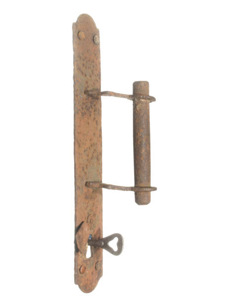 istock Ancient rusty door handle with keyhole and key isolated on white background. 905953734