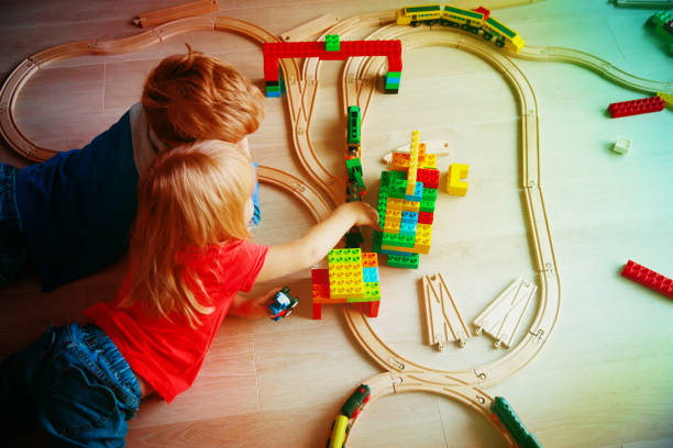 istock kids playing with toy railroad and trains 905956370