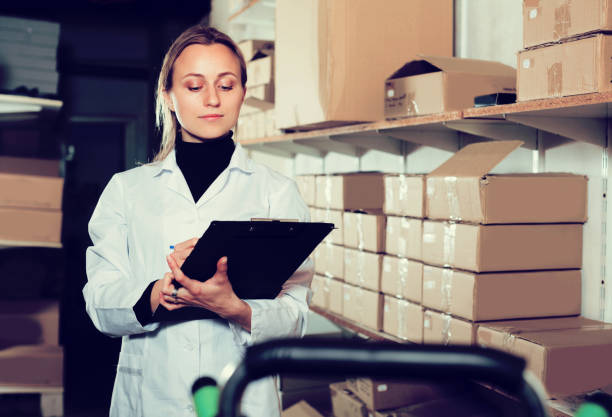istock Female worker transporting cart cardboard  cases 905956422