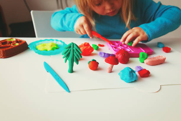istock Child playing with clay molding shapes 905956910