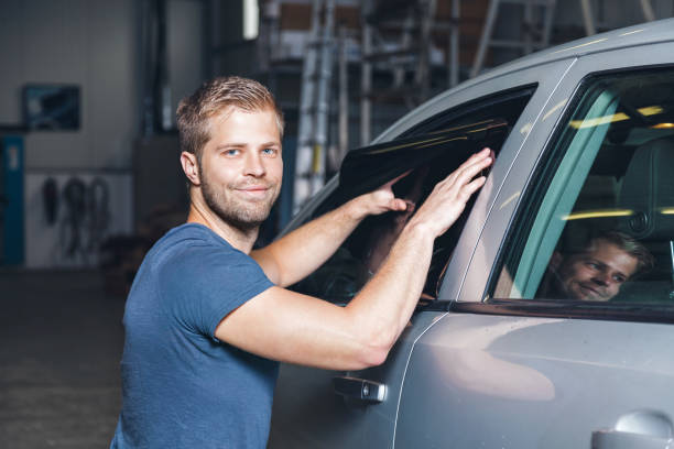 istock Applying tinting foil onto a car window 905957150