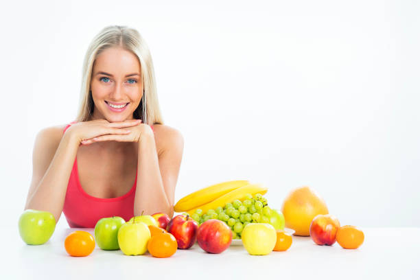 Smiling pretty woman with fruits