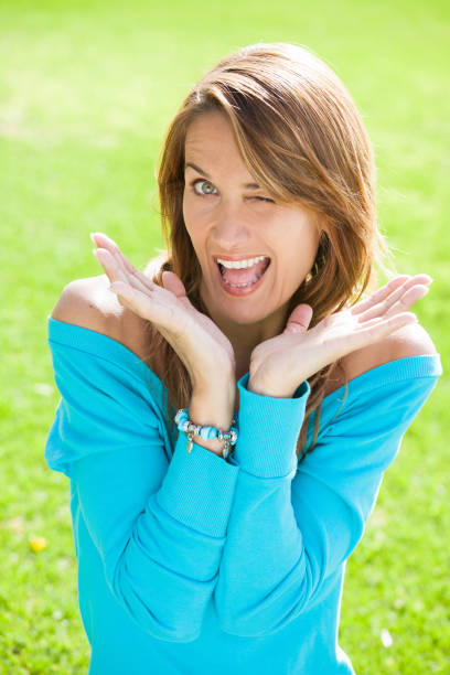 istock winking woman in summer 905960224