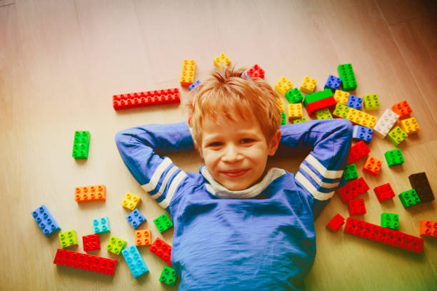 istock cute little boy love playing with plastic blocks 905960414