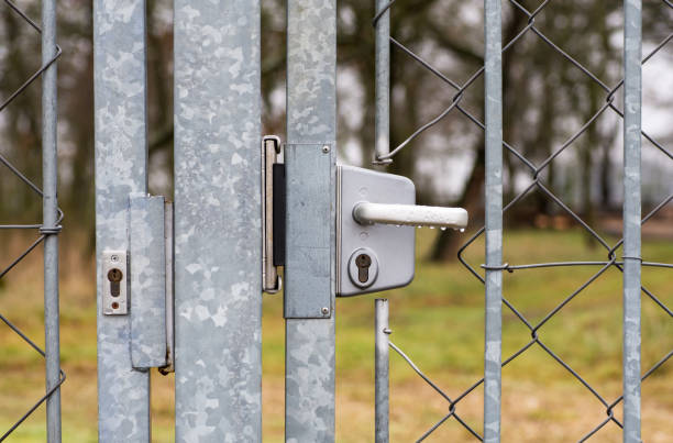 istock Tin closed door with lock and handle on fence mesh 905961598