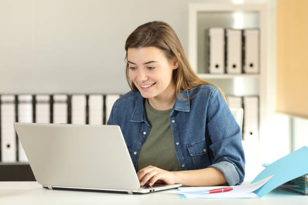 istock Happy intern teenager working at office 905963992