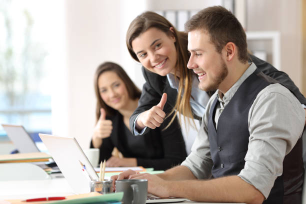 istock Colleagues congratulating to a motivated worker at office 905968954