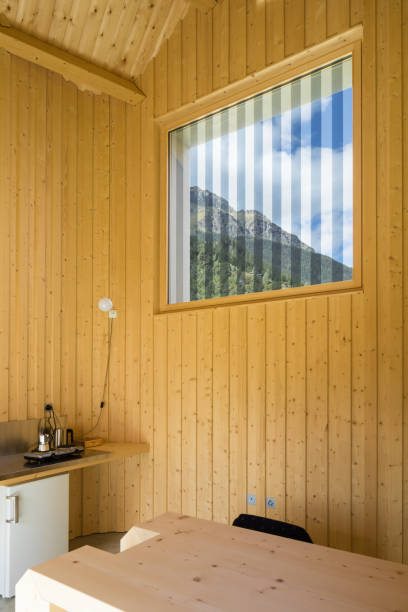 istock Wooden wall with window, striped glass 905970388
