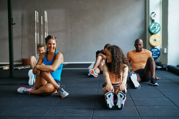 istock People talking together on a gym floor after working out 905970600