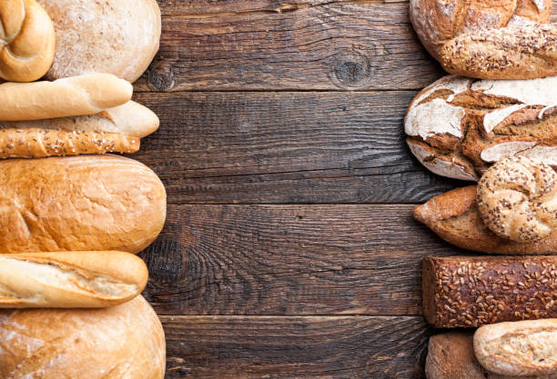 istock Delicious fresh bread on wooden background 905970848