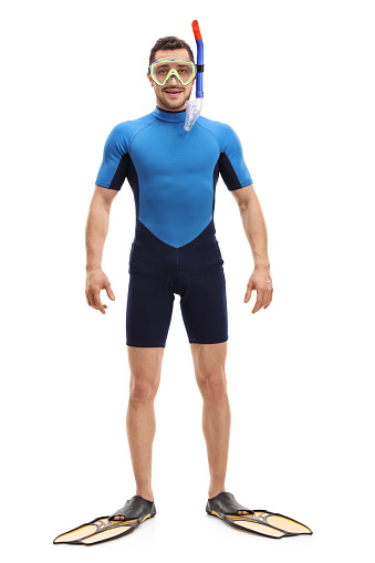 Full length portrait of a man in a wetsuit with snorkeling equipment isolated on white background