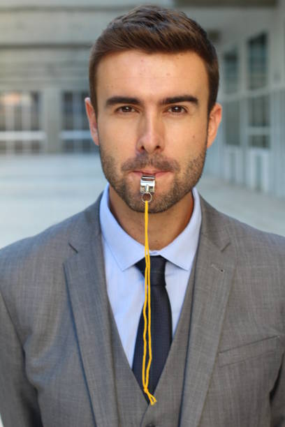 Cute businessman blowing a whistle Cute businessman blowing a whistle. whistling stock pictures, royalty-free photos & images