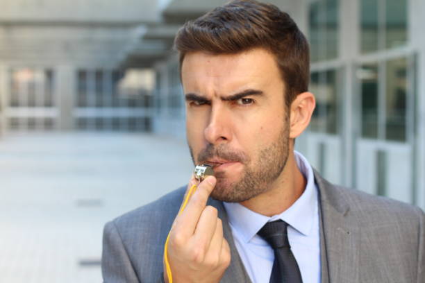 istock Mad businessman blowing a whistle 905973938