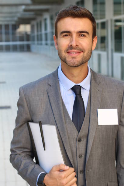 istock Businessman with white copy space in his name tag 905974674