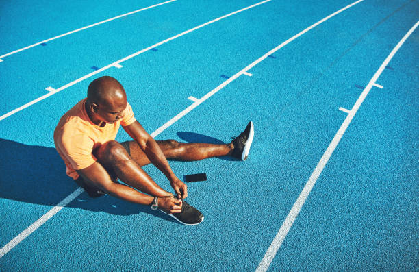 istock Young athlete tying his shoes before for a track run 905978494