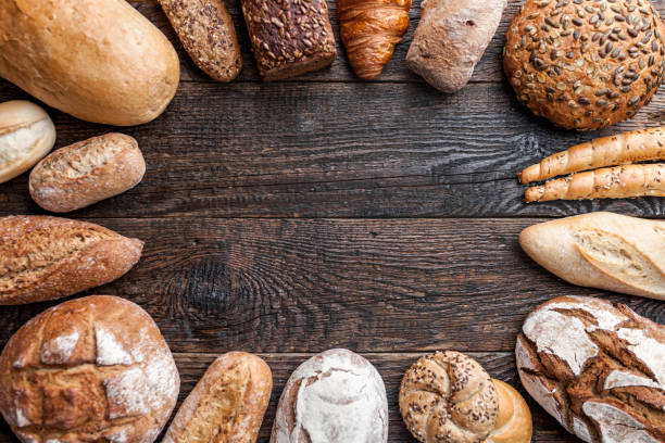 istock Delicious fresh bread on wooden background 905978736
