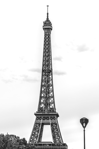 Paris, France - May 1, 2013: Tour Eiffel as seen from the Gardens of Trocadero, with some people and tour buses. In the background the Quartier Du Trocadero