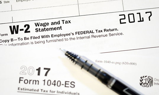 The process of filling out the W-4 form, shallow depth of field