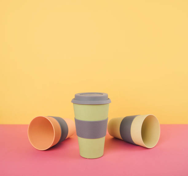 istock Take away coffee cups on colorful paper background. 905982314