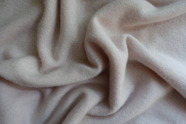 istock Draped simple white fluffy woolen knitted fabric 905983440