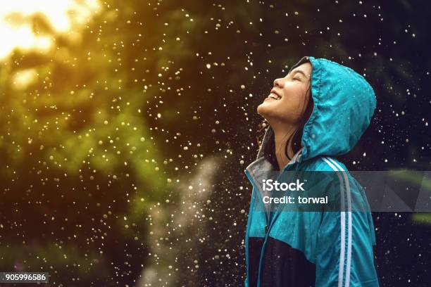 Asian Woman Wearing A Raincoat Outdoors She Is Happy Stock Photo - Download Image Now