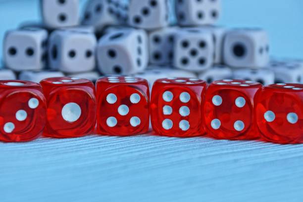istock a row of red dice on a blue background 905997608