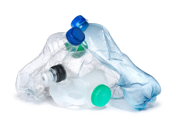 pile of plastic bottles garbage landfill a pile of plastic bottles, crumpled and ready for trash and landfill. cut out on a pure white background with copy space and a natural drop shadow. the image highlights the environmental and conservation issues with single use plastic bottles rubbish heap stock pictures, royalty-free photos & images