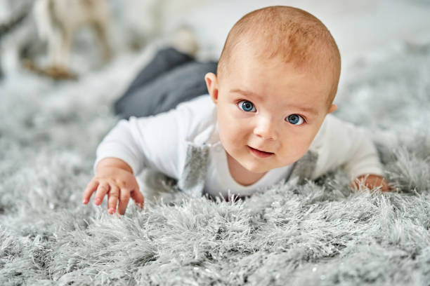 istock Baby boy lying on his belly 906001166