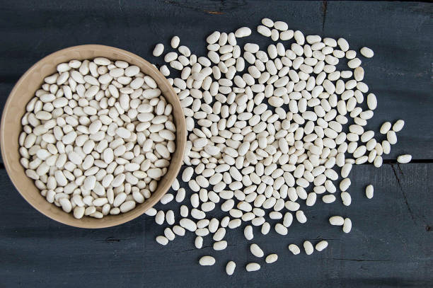 istock dry beans. To make bean biscuits, white dry bean sprouts, dry raw beans on the plate, 906005292