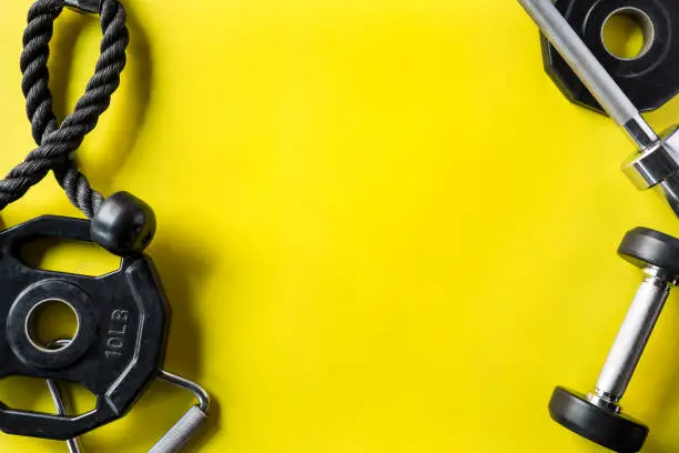 Photo of Sports gym equipment on yellow background