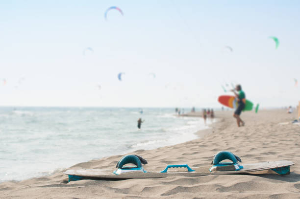 kite-surfing board and kite-surfer approaching the water