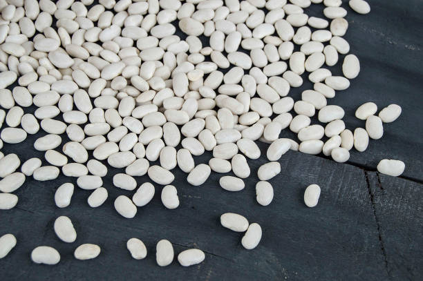 istock dry beans. To make bean biscuits, white dry bean sprouts, dry raw beans on the plate, 906005798