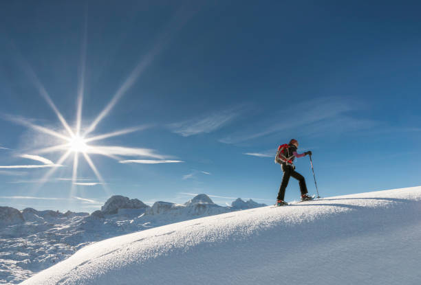 istock Snowshoeing on a snow cornice at Dachstein Mountains, Austria. 906005986