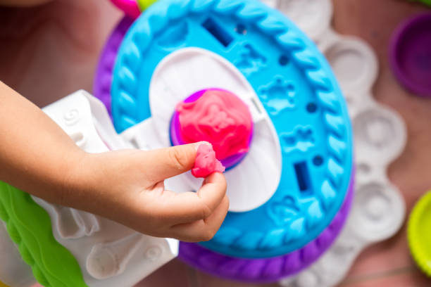 istock Children playing dough with mold to make many funny shapes from their hands 906016974