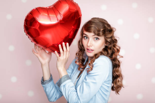 istock woman with heart shaped air balloons 906020488