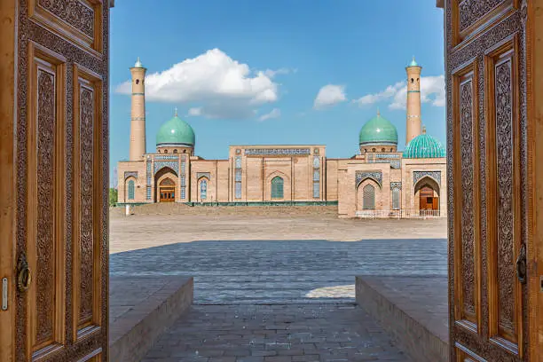 Khast Imam religious complex through wooden doors in Tashkent, Uzbekistan.