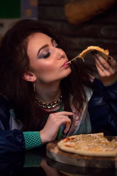 istock girl in the 90's style eats pizza 906021822